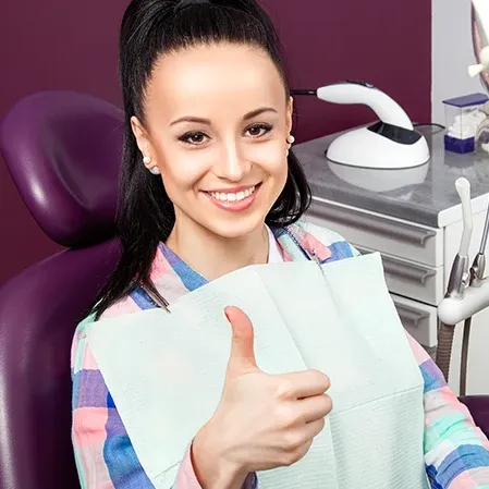A female patient sitting in a dental exam chair